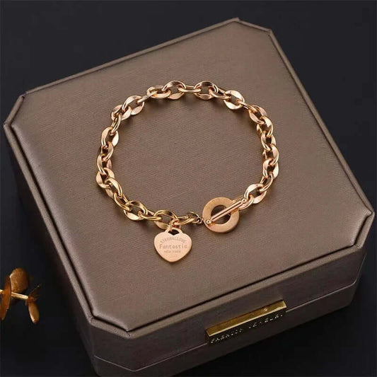 Close-up of the surface finish on heart charm chain bracelet with a steel toggle clasp