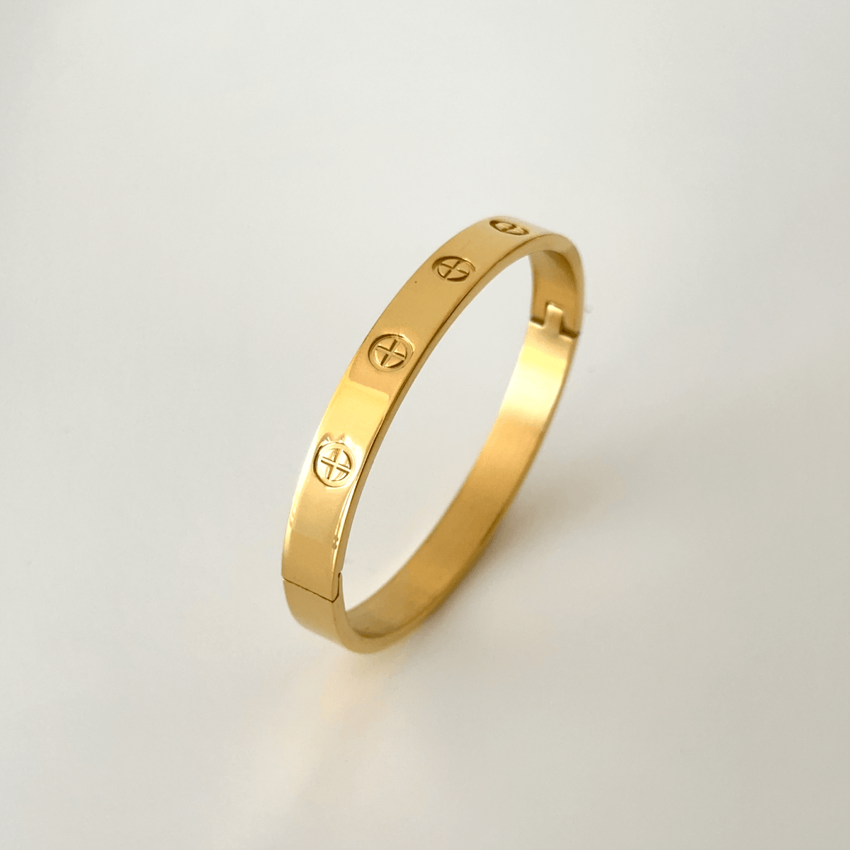 Gold plated stainless steel couple bangle photographed in its packaging