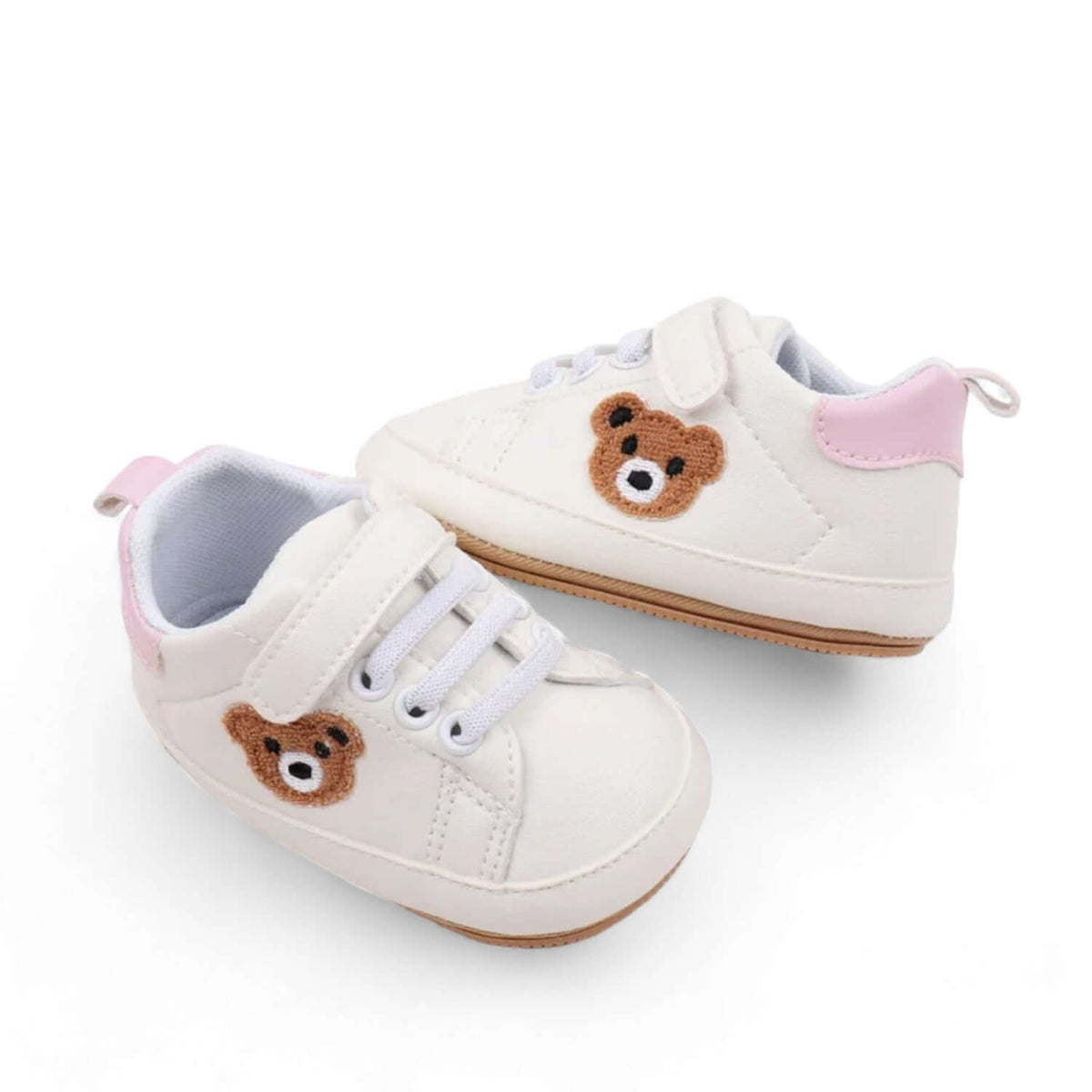 Top-down view of pink teddy bear baby sneakers with a soft sole