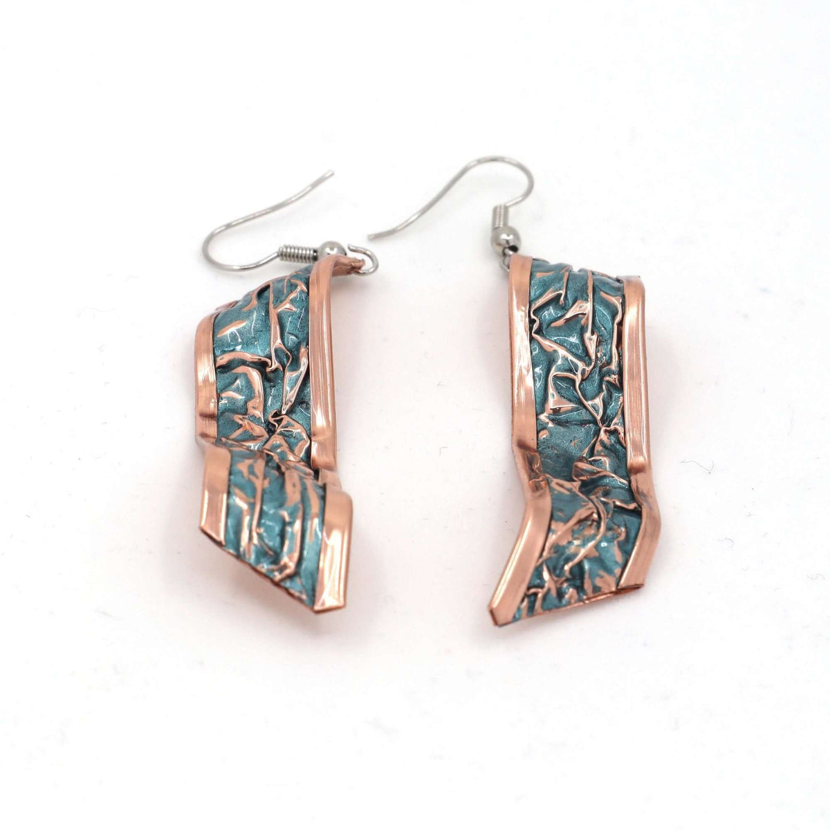 Top-down view of four-piece turquoise wrinkled copper jewellery set