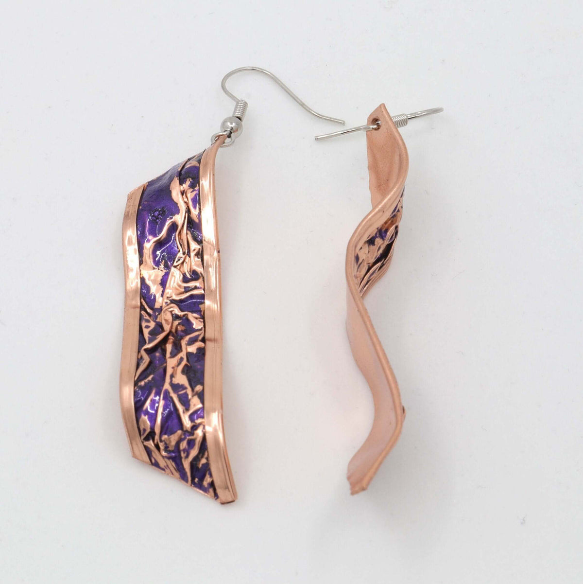 Four-piece purple wrinkled copper jewellery set displayed on a plain background