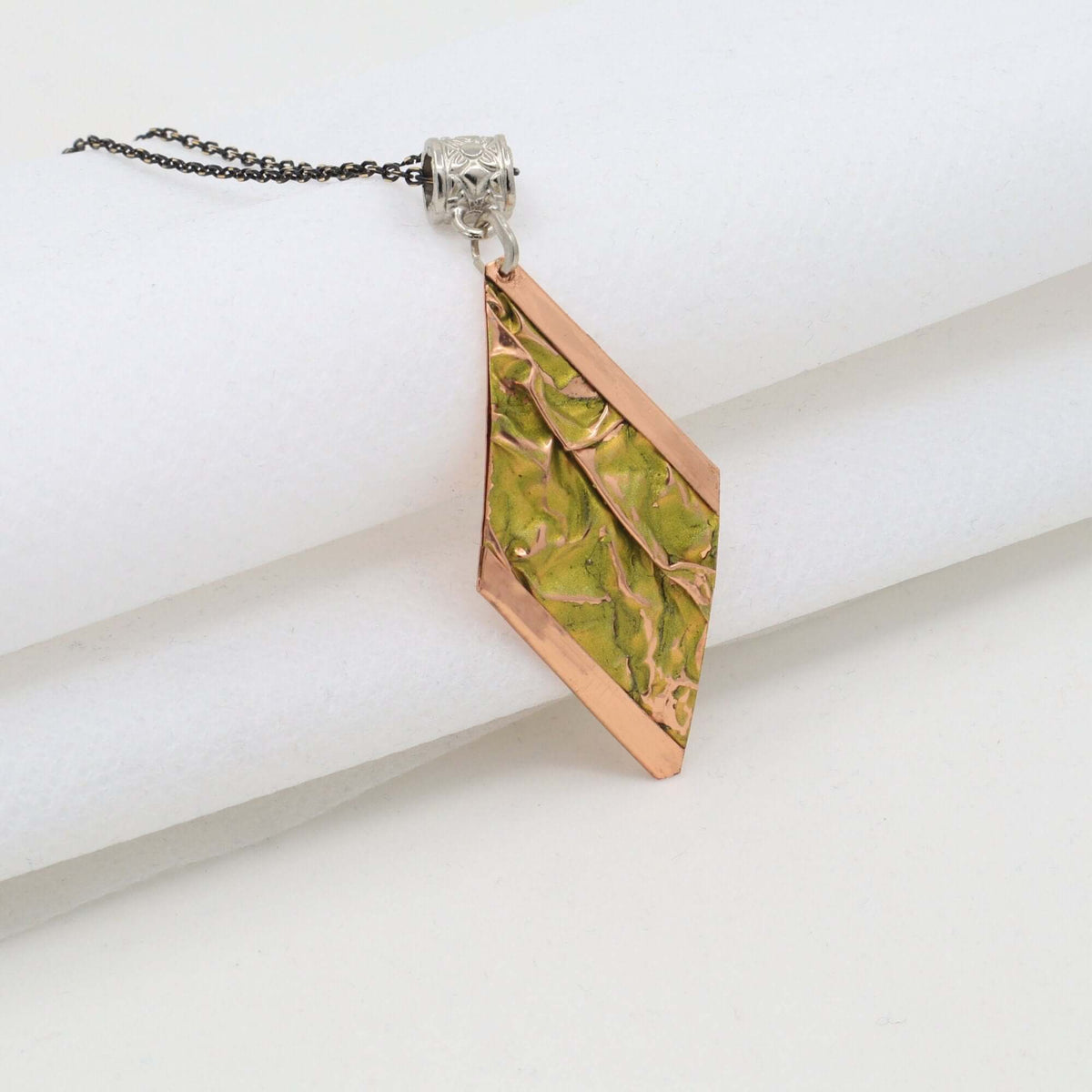 Four-piece yellow wrinkled copper jewellery set displayed on a plain background