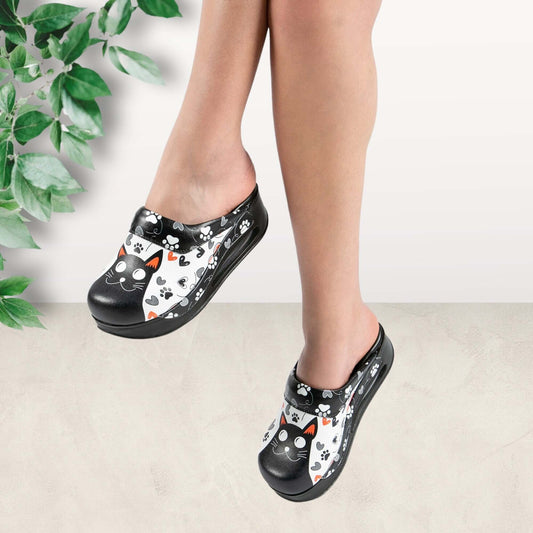 Side profile of handmade black cat design leather clog slippers with an Air Clogx sole