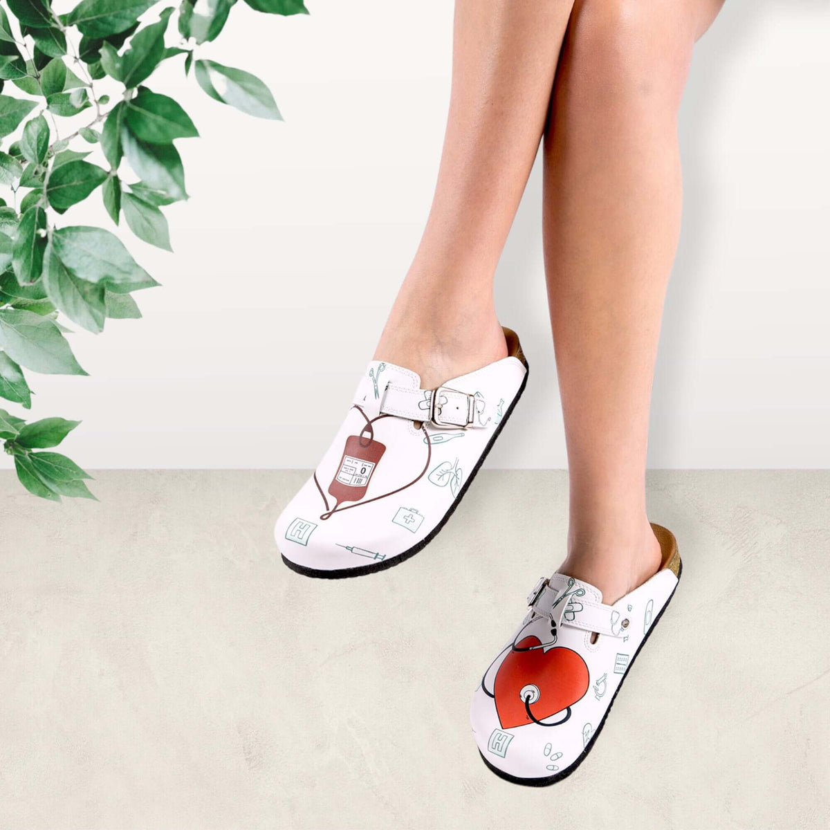 Pair of nurse print leather cork sole clogs side by side