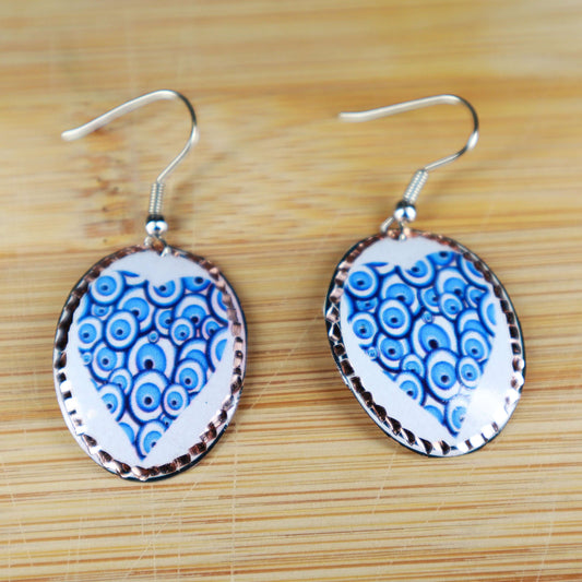 Close-up of the copper texture on handcrafted blue heart copper circle earrings
