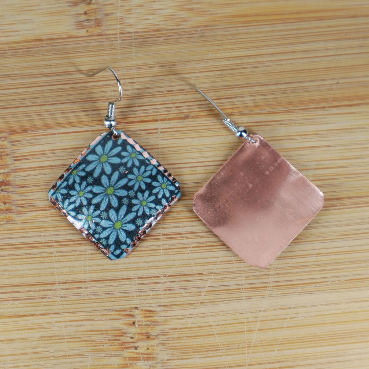 Artisan turquoise flower copper square earrings displayed on a plain background