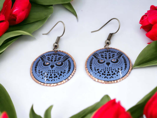 Close-up of the copper texture on handcrafted blue owl copper circle earrings