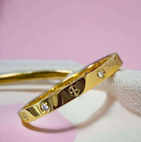 Open end detail on gold stainless steel cuff bracelet with zirconia stones
