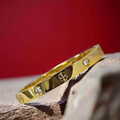 Gold stainless steel cuff bracelet with zirconia stones worn on the wrist