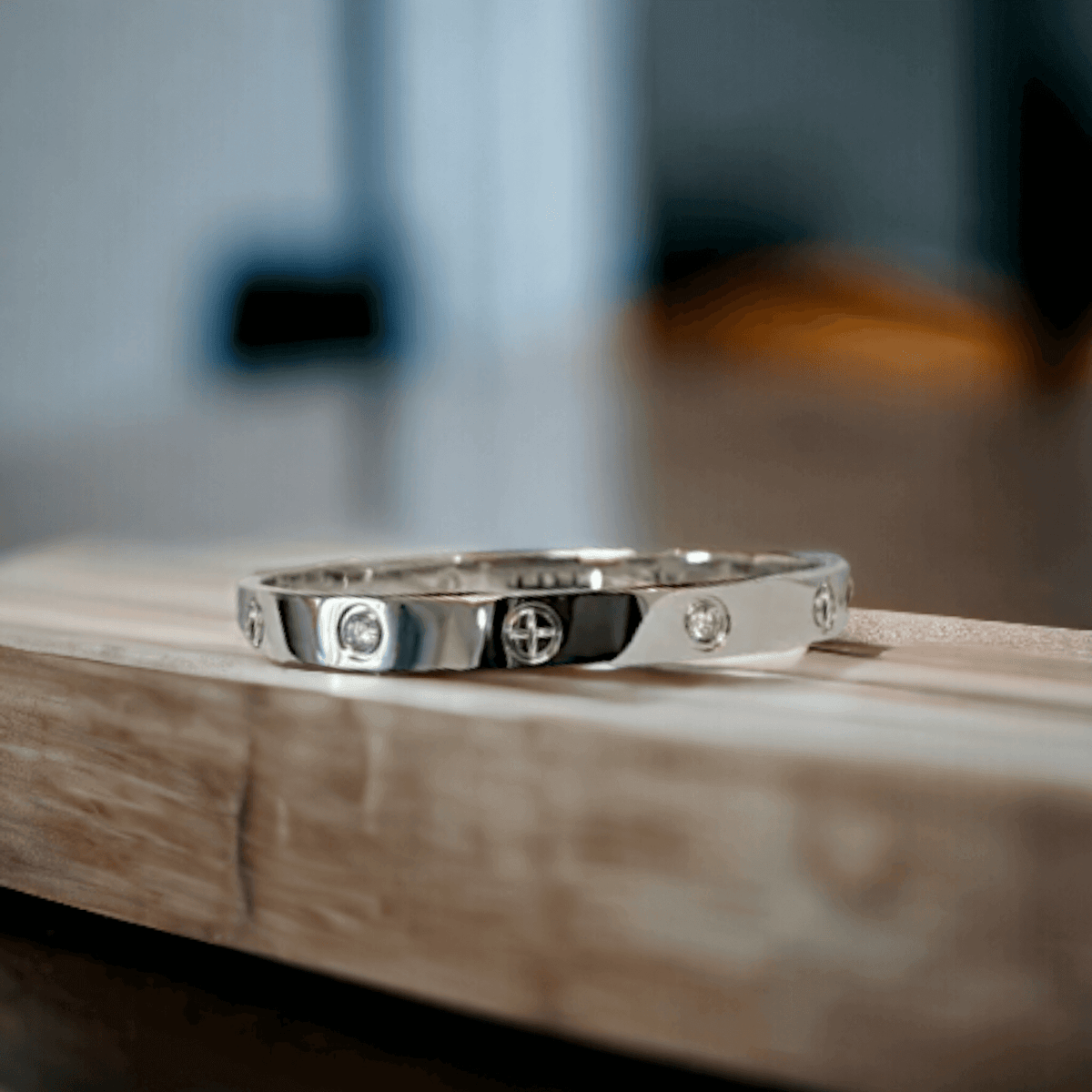 Top-down view of silver stainless steel cuff bracelet with zirconia stones