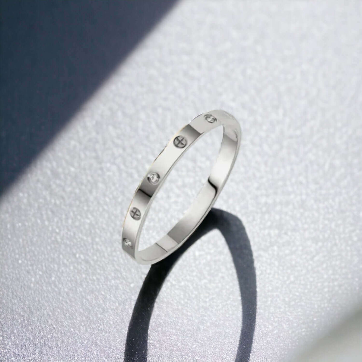 Open end detail on silver stainless steel cuff bracelet with zirconia stones
