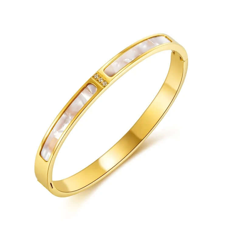 Gold bracelet with white stones on a white background