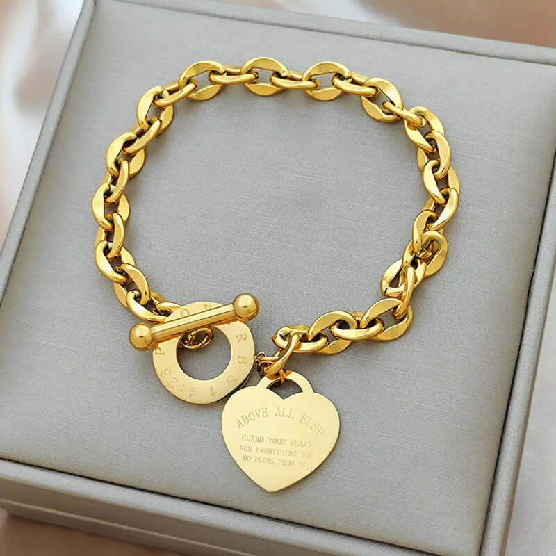 Heart charm chain bracelet with a steel toggle clasp photographed in its packaging