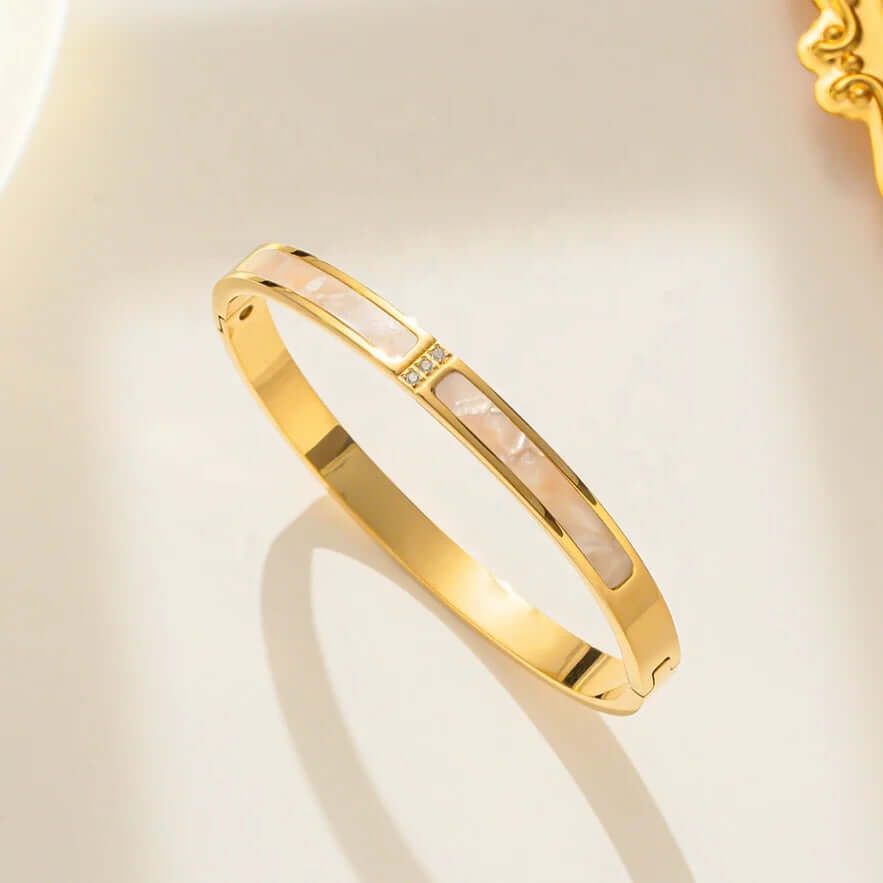 Gold bracelet with a subtle design on a light background