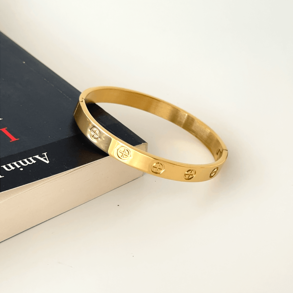 Angled view of gold plated stainless steel couple bangle
