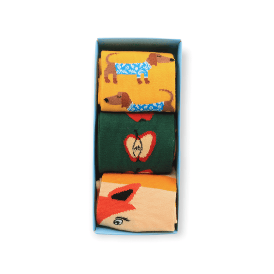 The full three-piece socks box set with sausage dog fox and apple designs laid flat