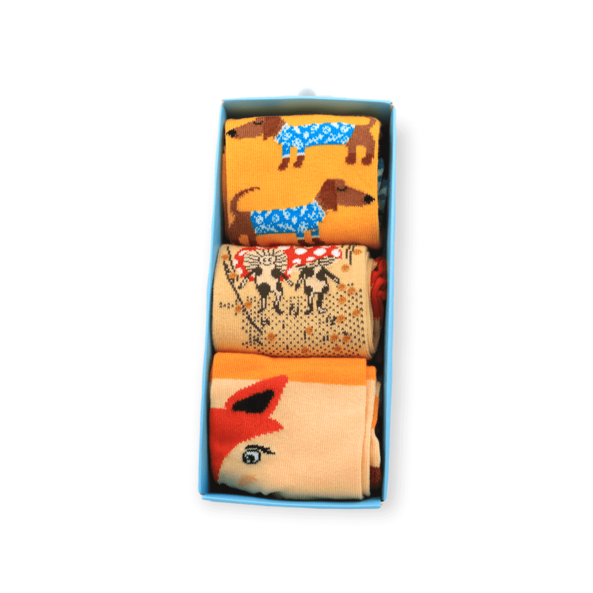 The full three-piece socks box set with sausage dog mushroom and fox designs laid flat
