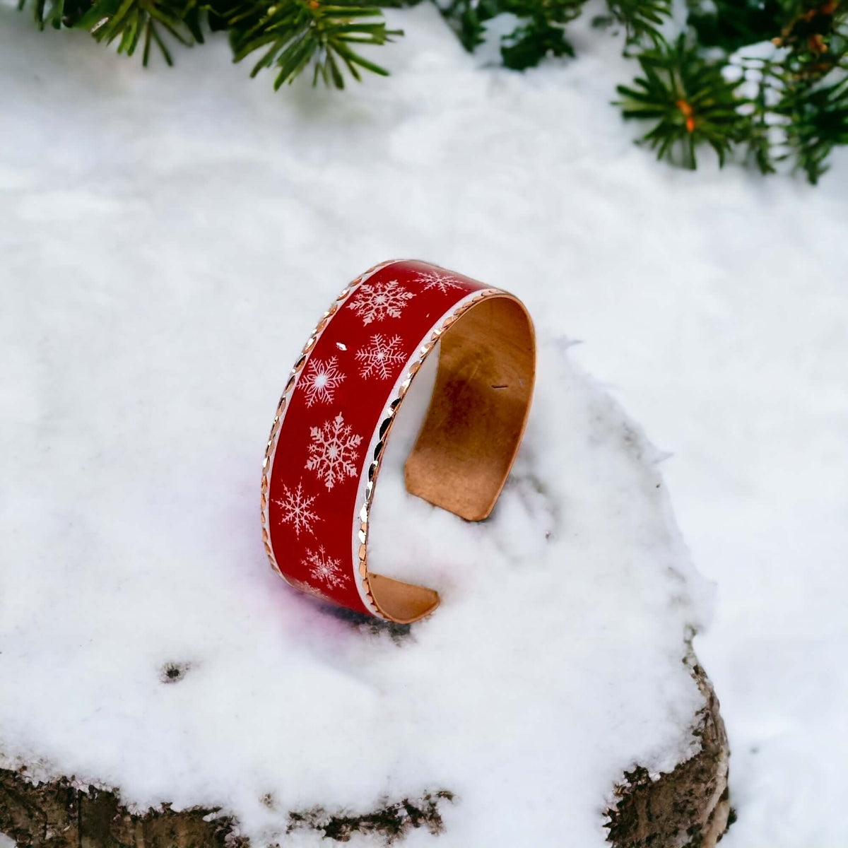 Angled view of festive copper snowflake Christmas bracelet