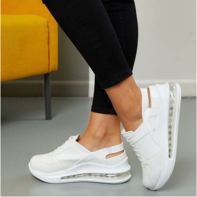 Angled three-quarter view of handmade white leather sneaker clogs with a Supermax sole
