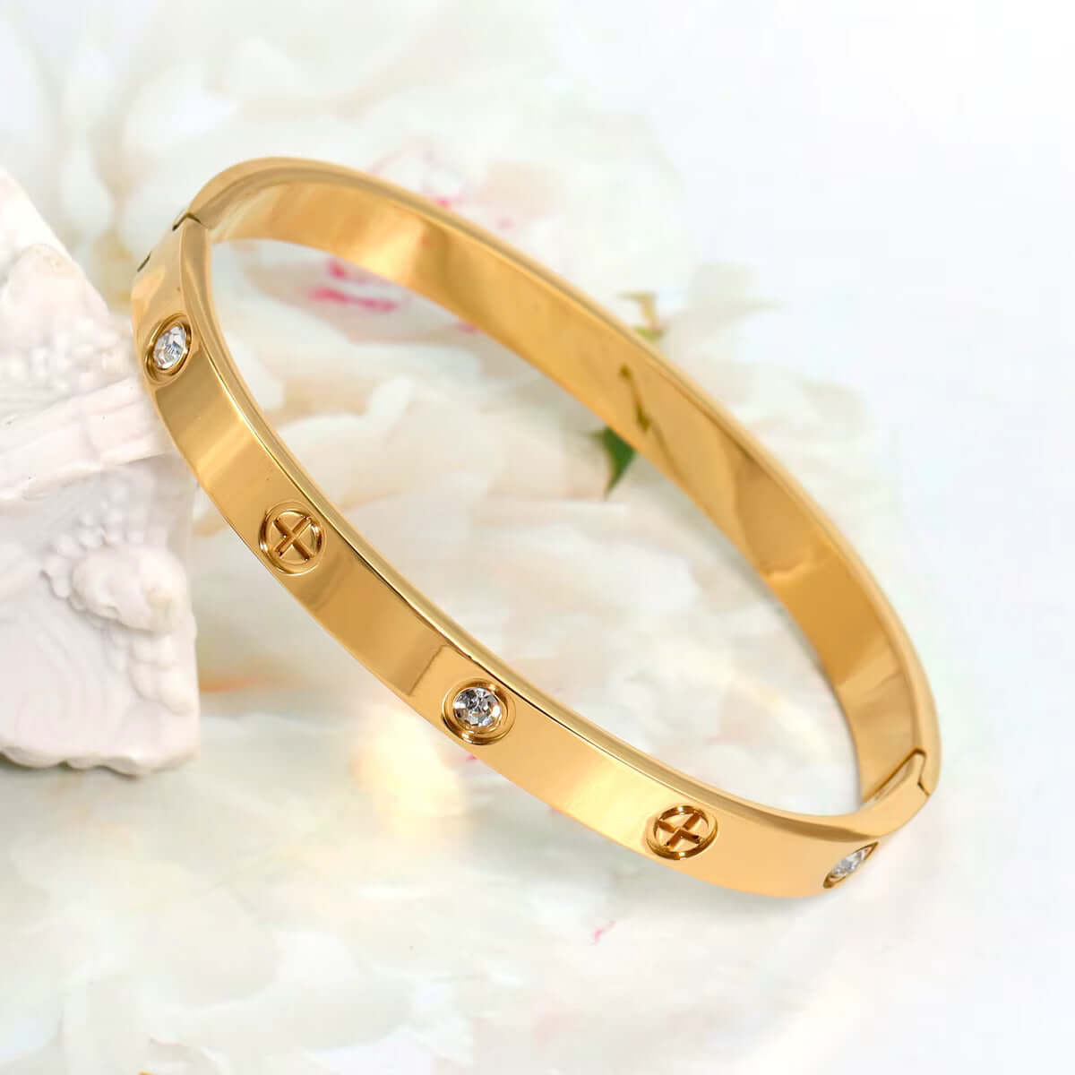 Front view of gold stainless steel cuff bracelet with zirconia stones
