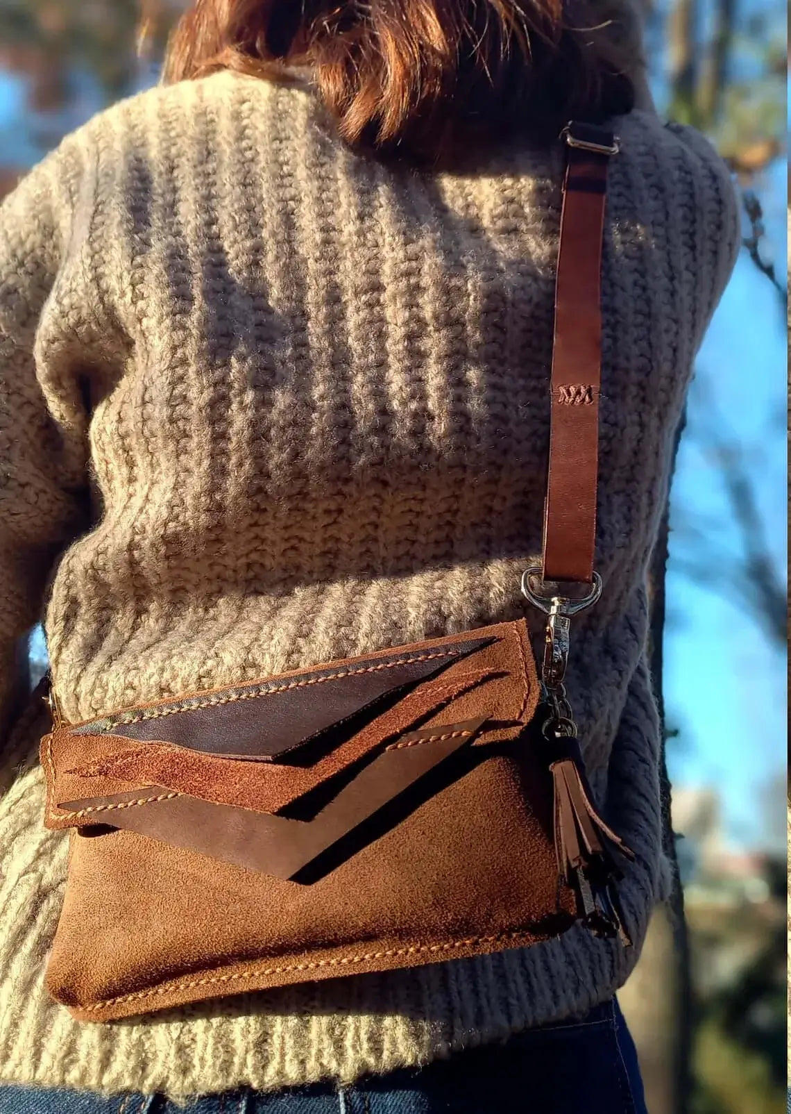 Strap and fastening detail on triangle brown leather belt bum bag in style 01