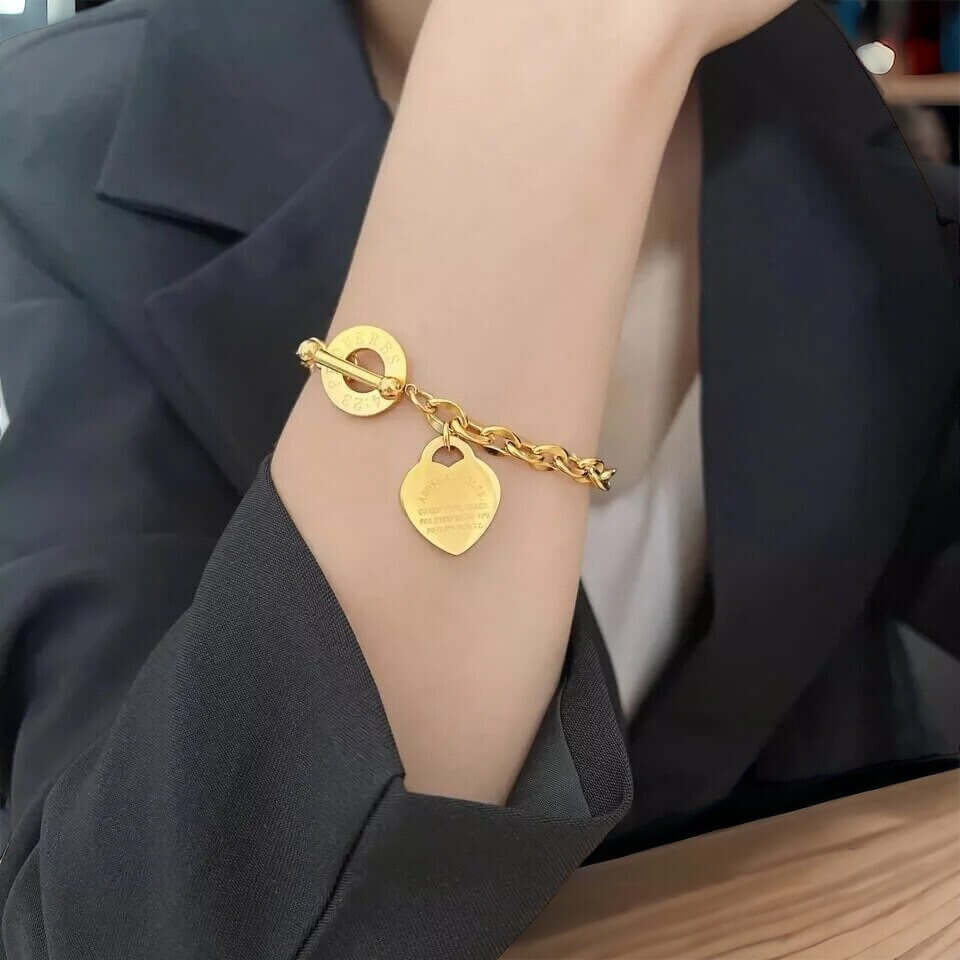 Toggle clasp detail on heart charm chain bracelet with a steel toggle clasp