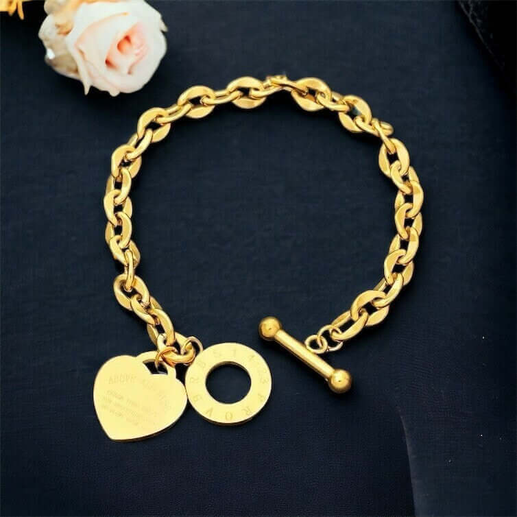 Heart charm chain bracelet with a steel toggle clasp worn on the wrist