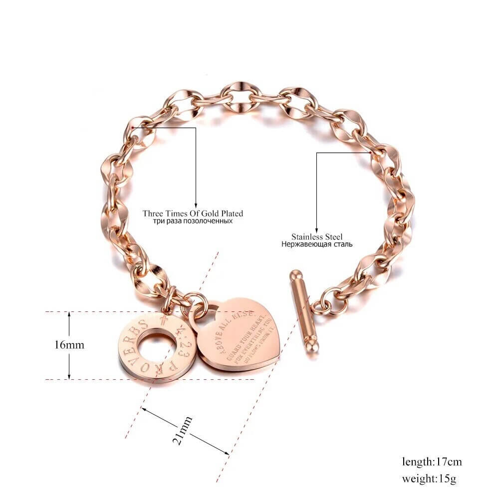 Top-down view of heart charm chain bracelet with a steel toggle clasp
