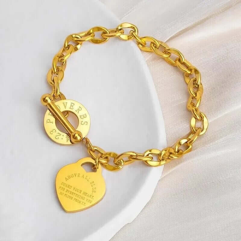 Side angle of heart charm chain bracelet with a steel toggle clasp