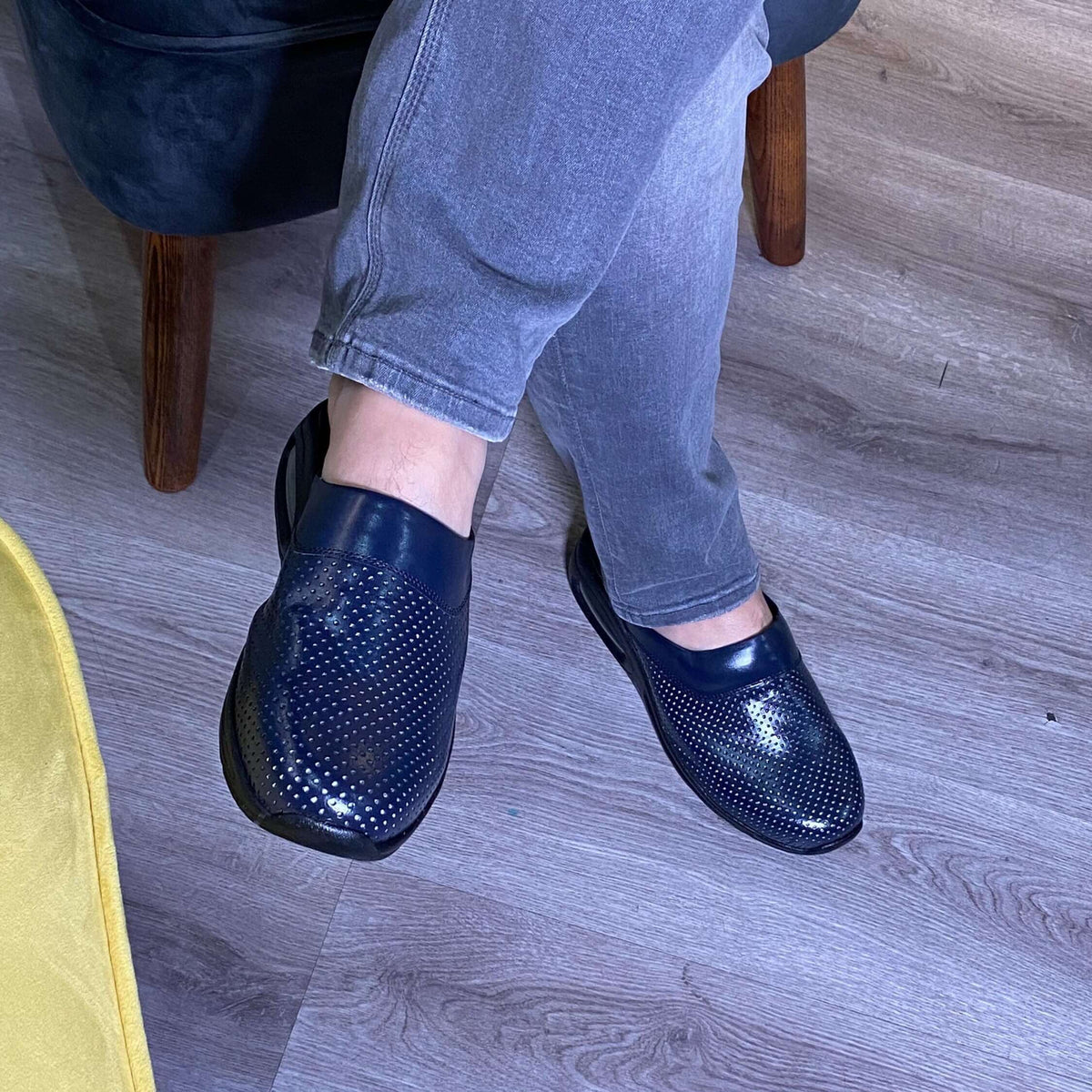 Side profile of navy blue leather clogs with a light Air Clogx sole