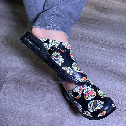 Front view of unisex skull and flower design leather clogs with a light sole