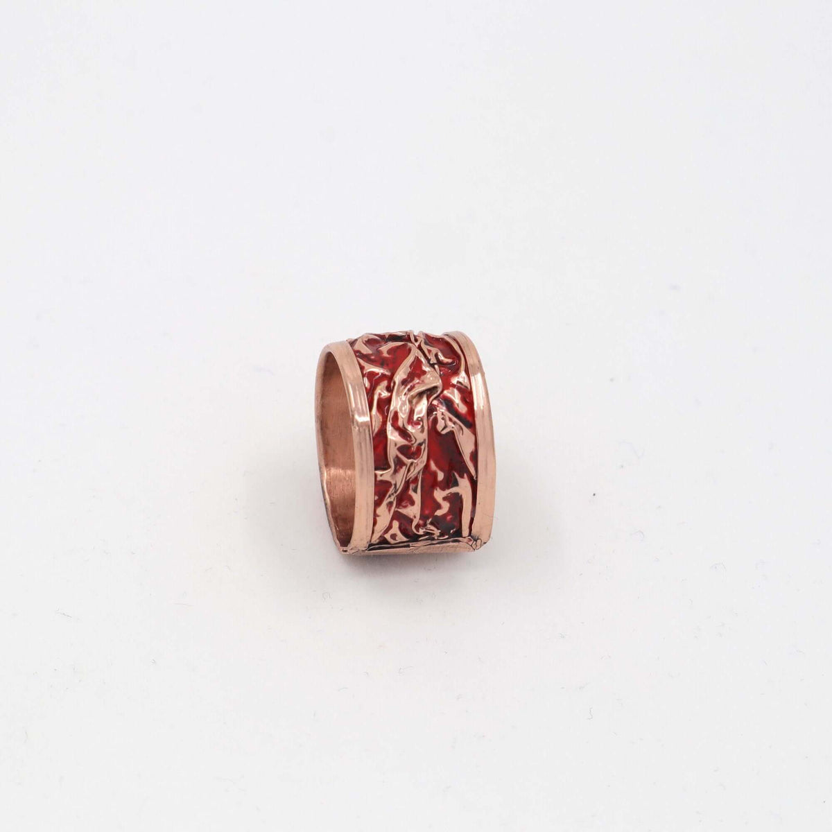 Close-up of one piece from four-piece red patterned wrinkled copper jewellery set
