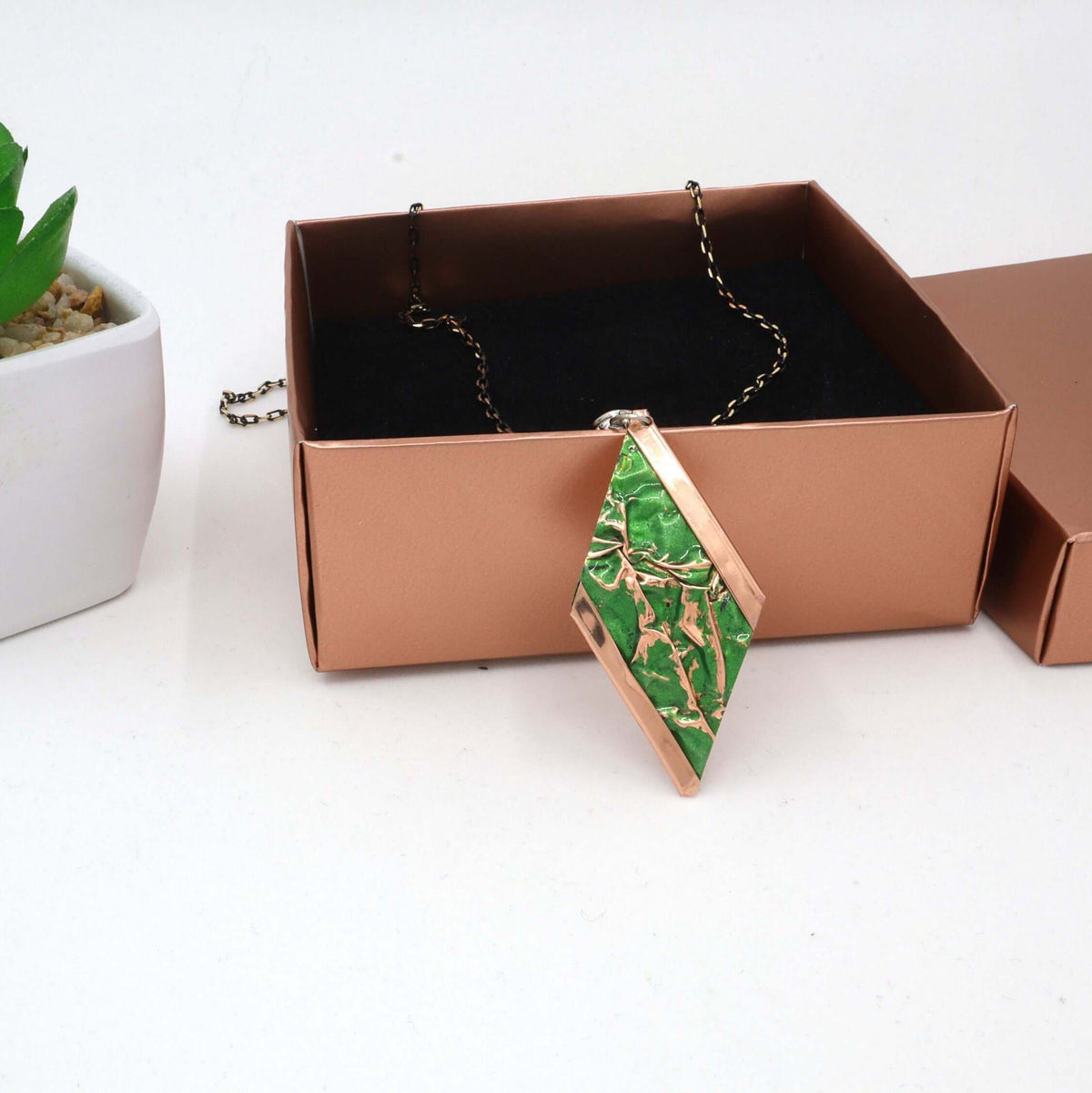 Complete green wrinkled copper jewellery set displayed on a plain background