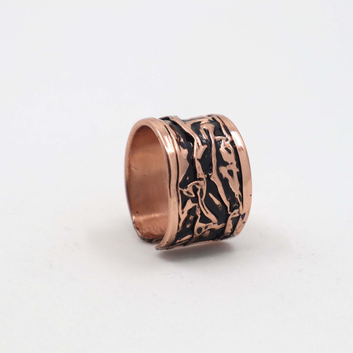 Angled view of handcrafted black wrinkled copper jewellery set