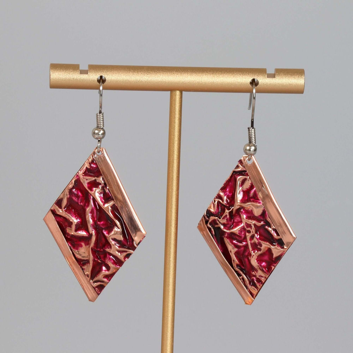 Close-up of the copper texture on handcrafted pink wrinkled copper earrings