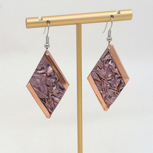 Front view of handcrafted pink wrinkled copper earrings