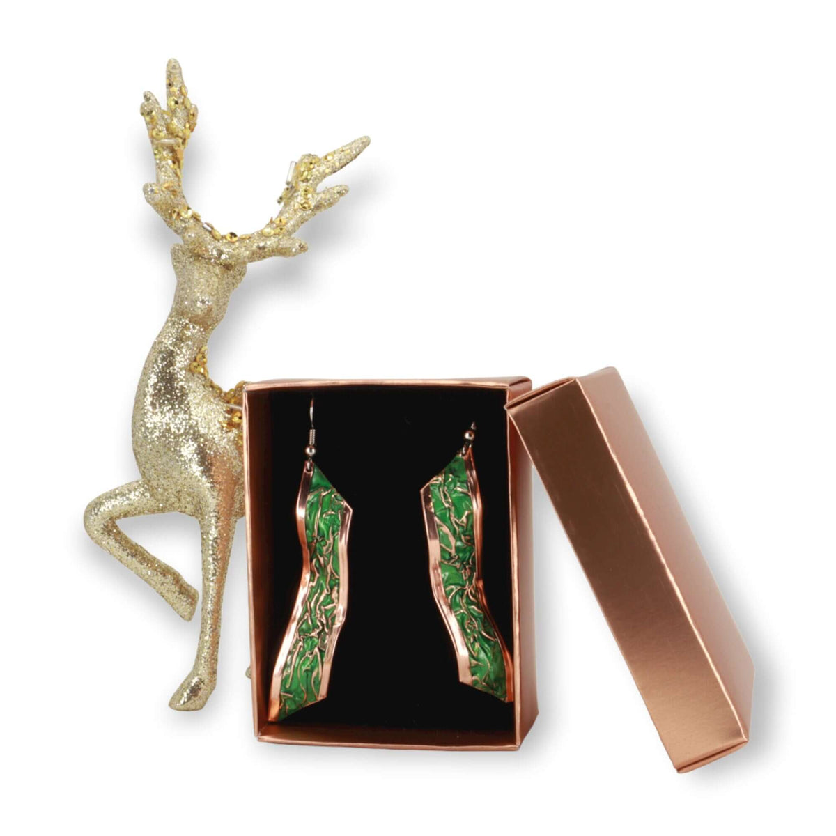 Side angle of handcrafted artisan green wrinkled copper earrings