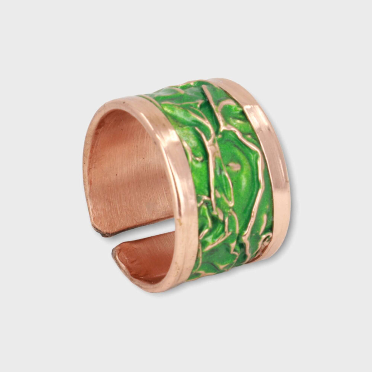 Handmade green wrinkled copper adjustable ring shown next to a hand for scale
