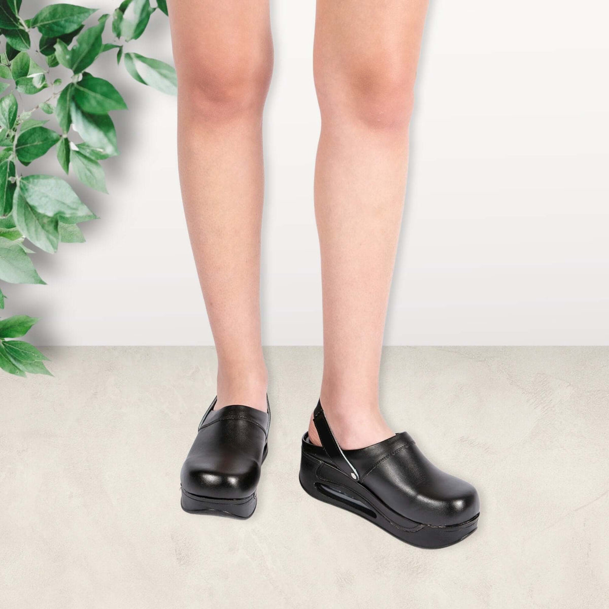 Sole and tread detail of black leather back strap clogs with an Air Clogx sole