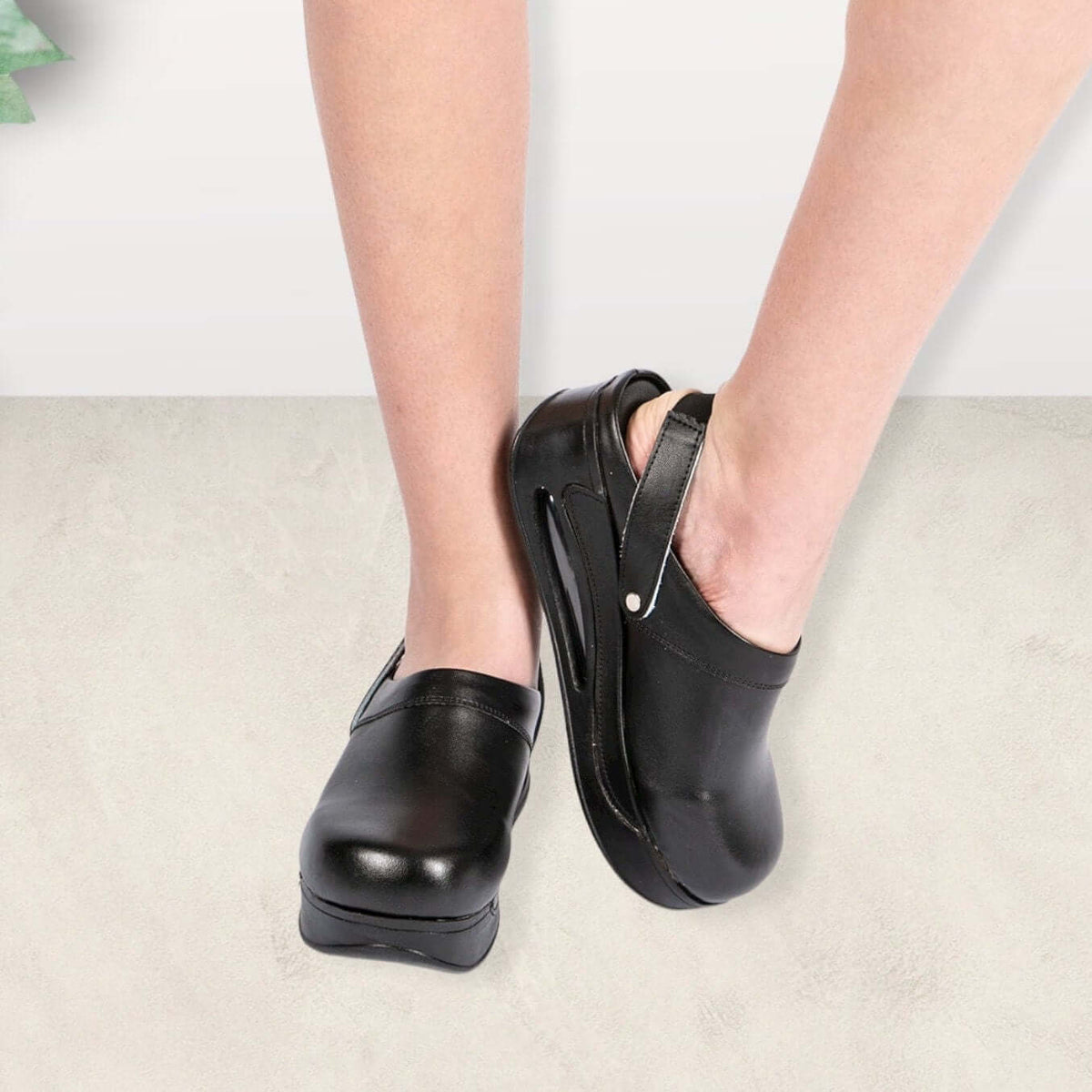 Front view of black leather back strap clogs with an Air Clogx sole