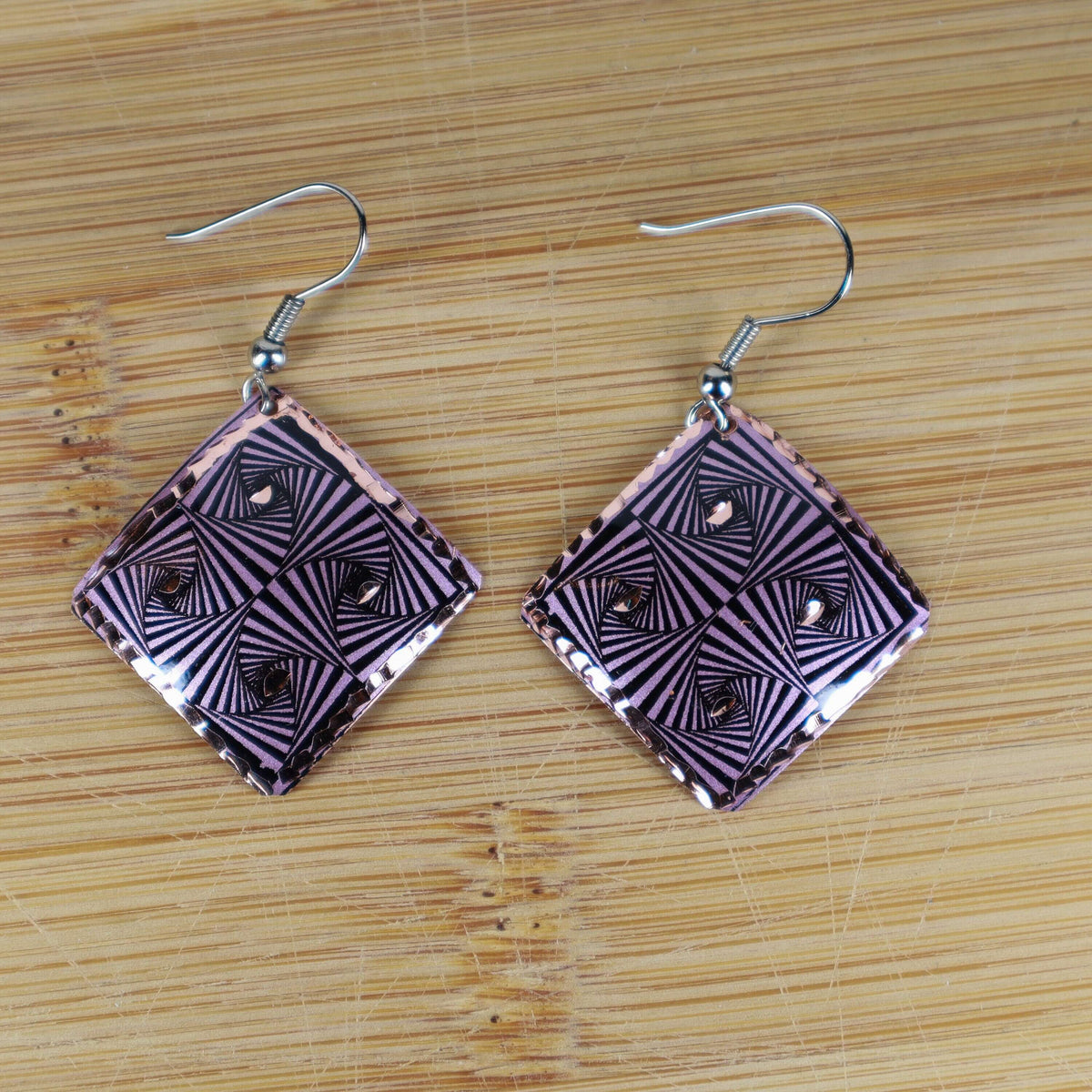 Close-up of the copper texture on artisan purple geometric copper square earrings
