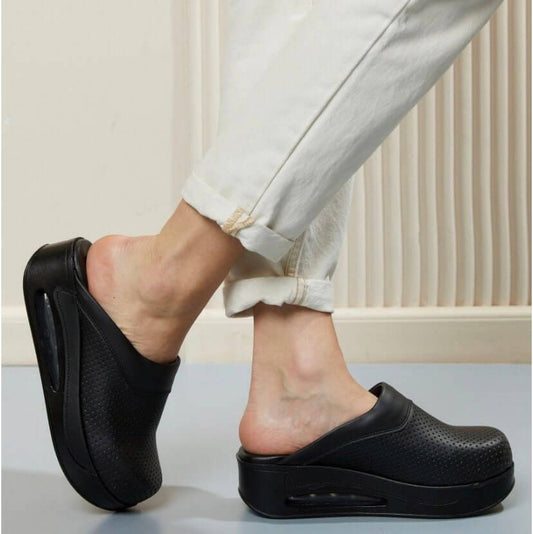 Front view of handmade black leather clogs with an Air Clogx sole