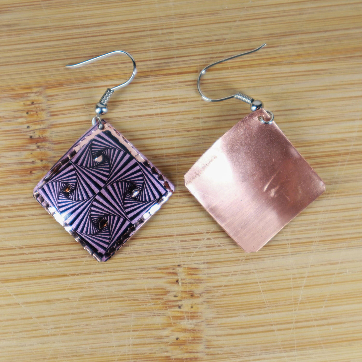 Artisan purple geometric copper square earrings worn on the ear