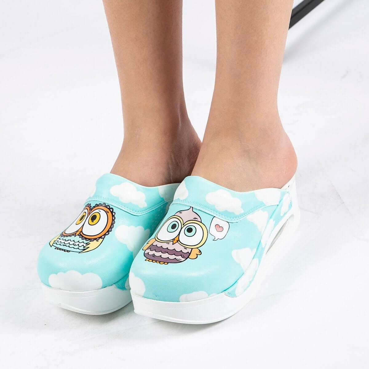 Front view of handmade blue owl design leather clog slippers with an Air Clogx sole