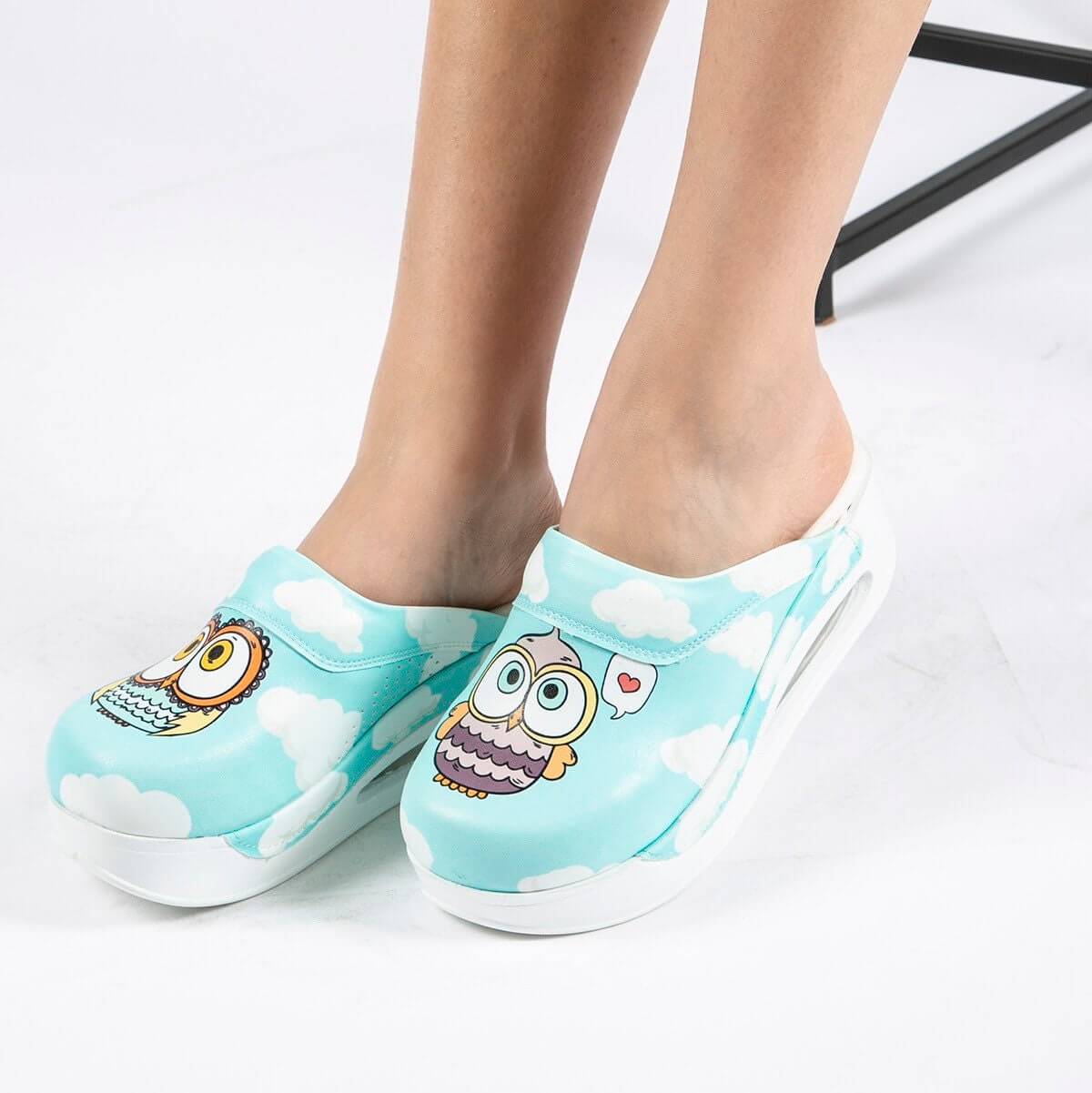 Handmade blue owl design leather clog slippers with an Air Clogx sole worn on the foot