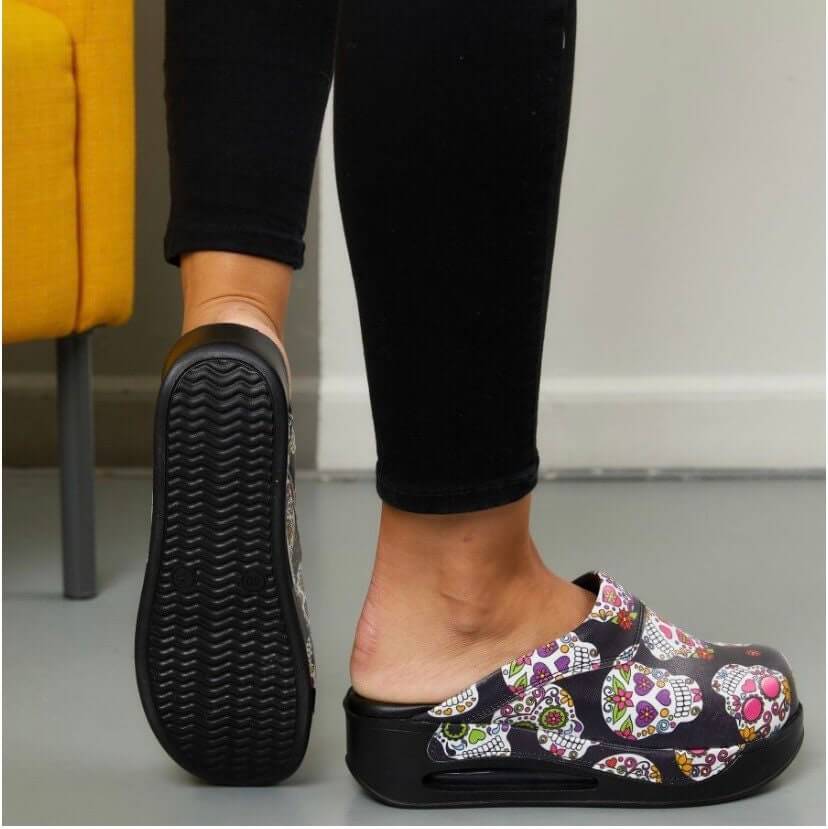 Side profile of handmade skull and flower leather clogs with an Air Clogx sole