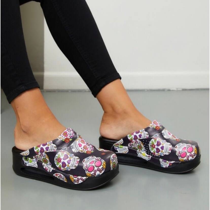 Front view of handmade skull and flower leather clogs with an Air Clogx sole