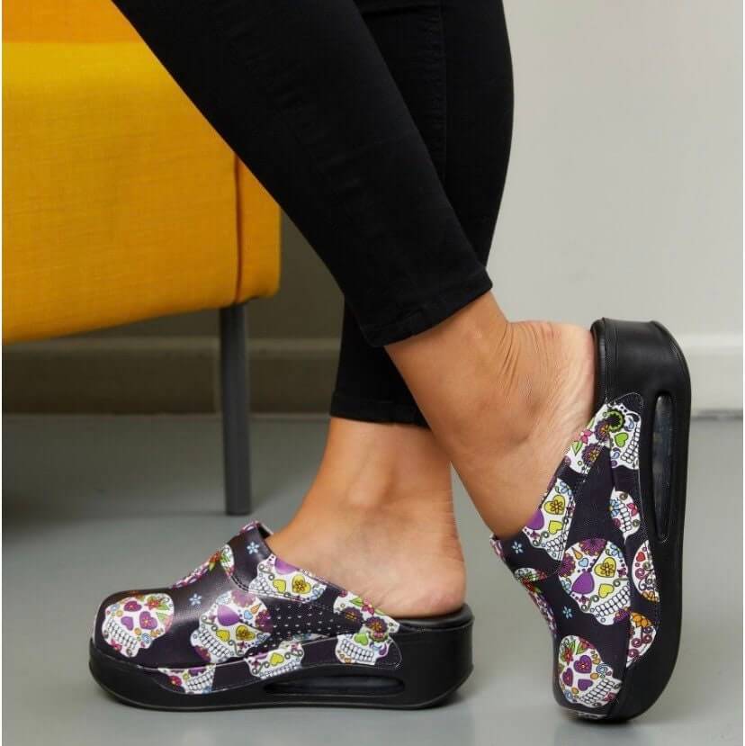 Handmade skull and flower leather clogs with an Air Clogx sole worn on the foot