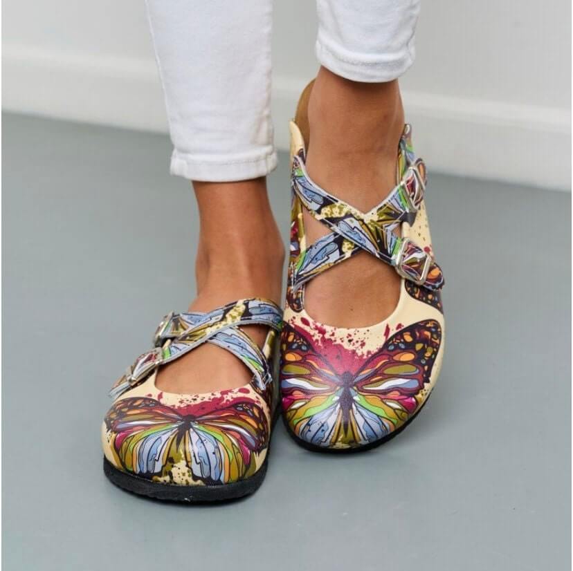 Yellow butterfly print leather clogs with cork sole, front view