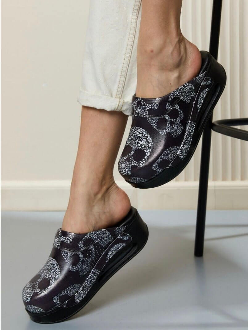 Top-down view of handmade skull design leather clogs with an Air Clogx sole